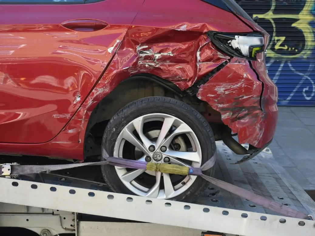 Car accident scene with insurance and legal documents being reviewed