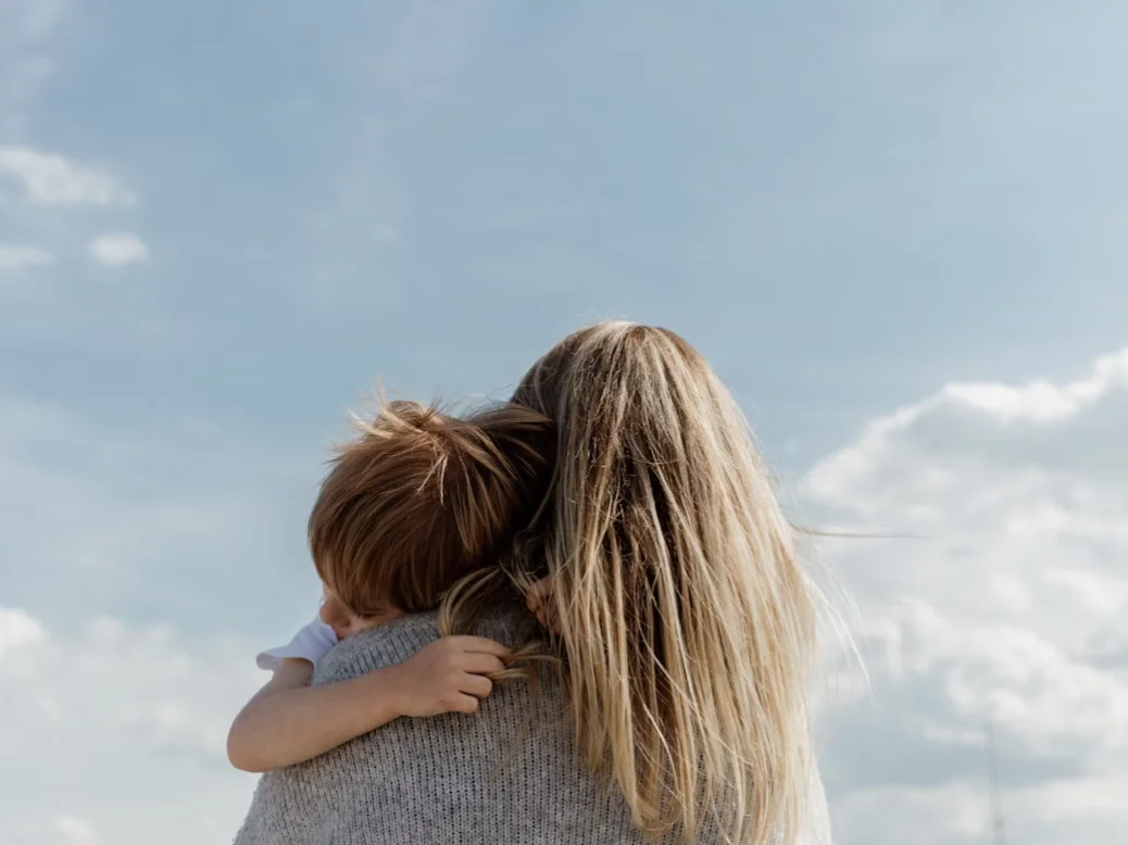 Mother and daughter smiling while opening a thoughtful Mother’s Day gift together