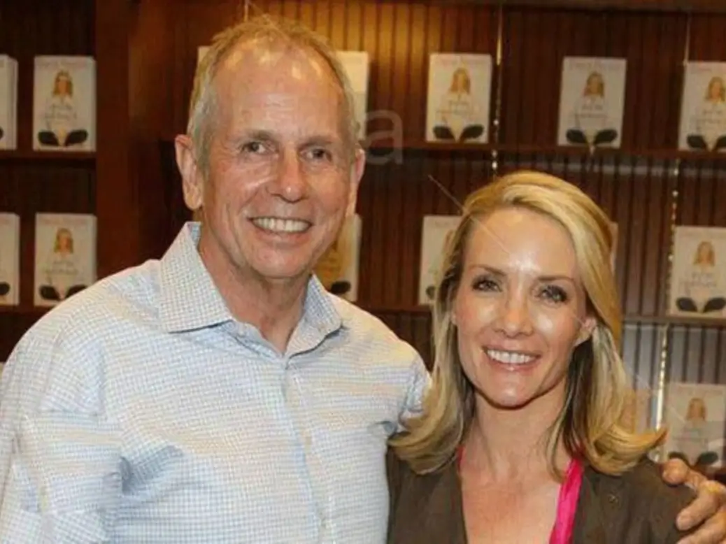 Peter McMahon posing at a business event with financial growth visuals in the background