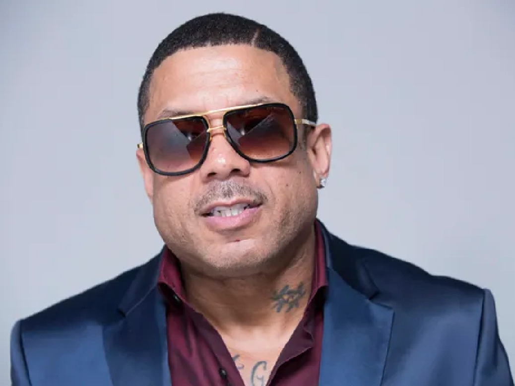 Rapper Benzino performing on stage with a mic