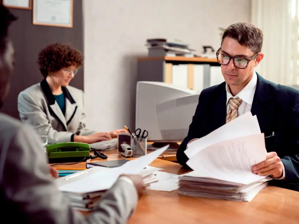 Tax documents and legal paperwork reviewing personal injury settlement details